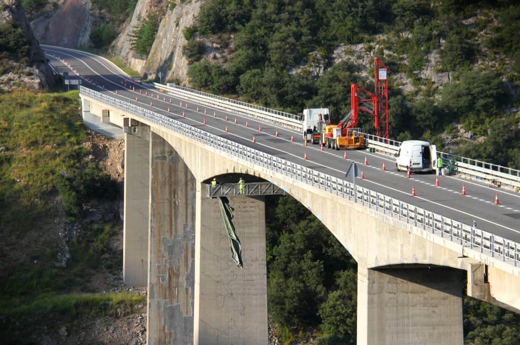 workers on tall bridge making repair MCI-2044